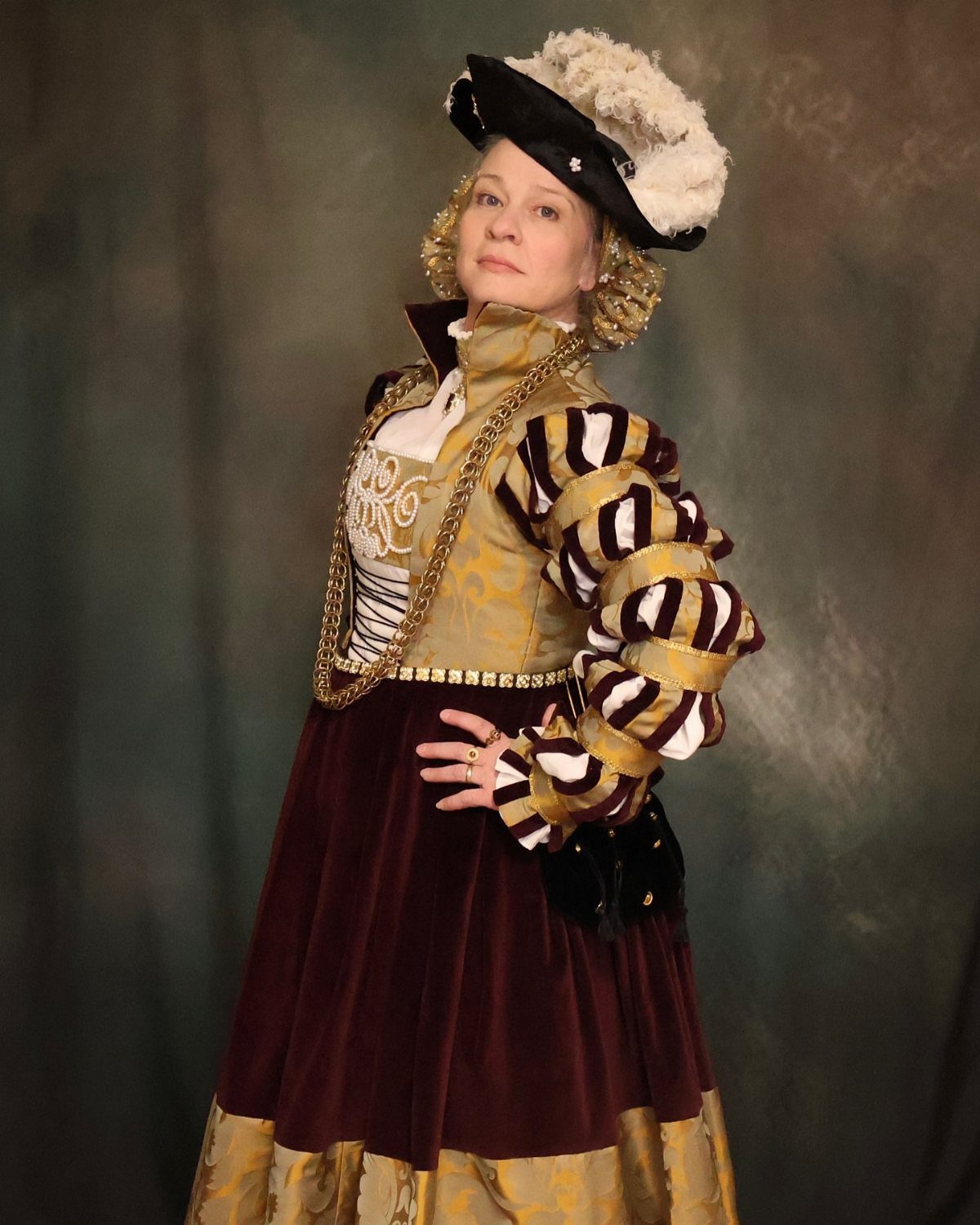 16th Century Fashion for Women: 9 Gown and Bodice Ideas 6 Woman in 16th-century fashion wearing a gold bodice and red velvet skirt.