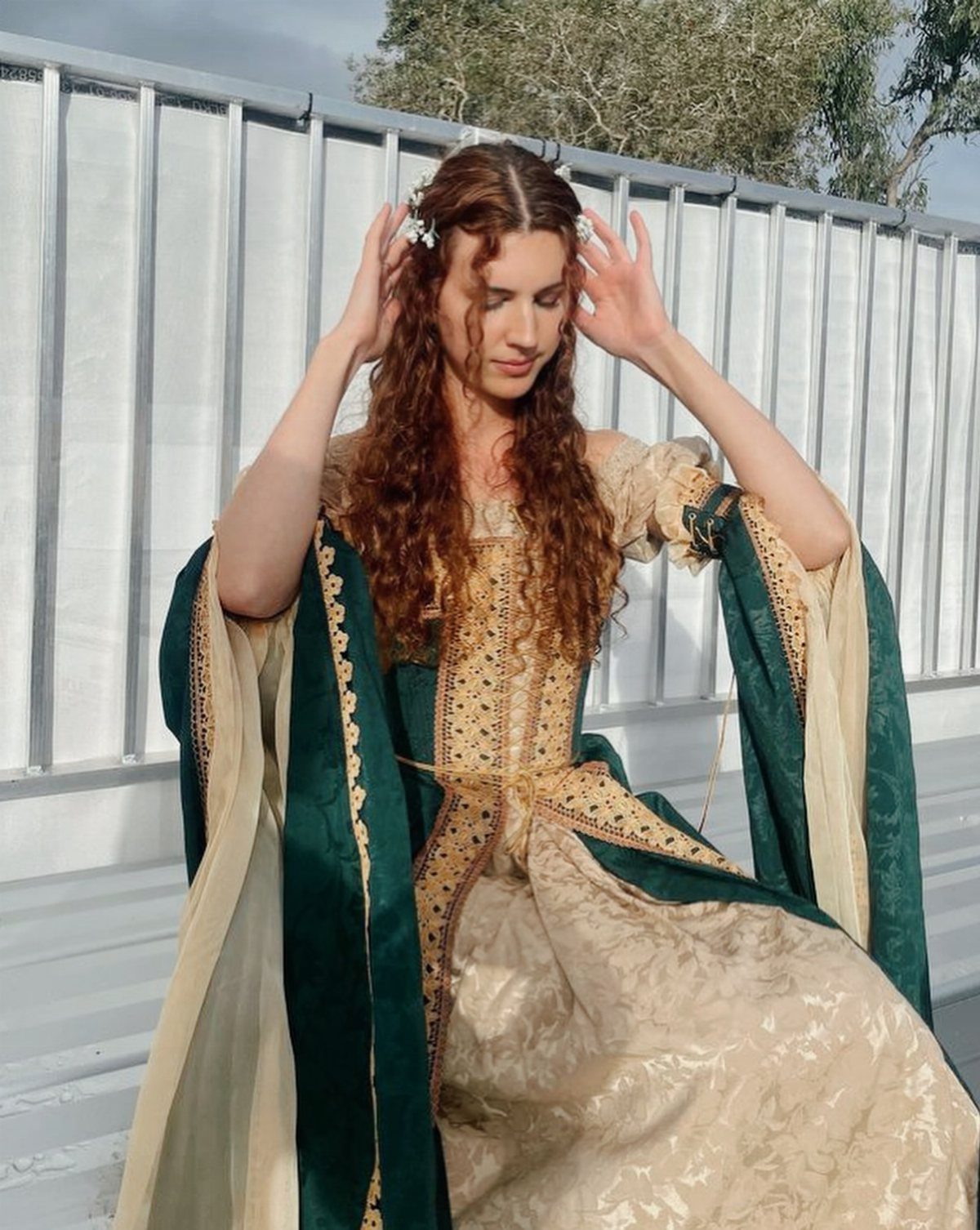 16th Century Fashion for Women: 9 Gown and Bodice Ideas 2 Woman in a gold and green 16th century style gown posing outdoors.