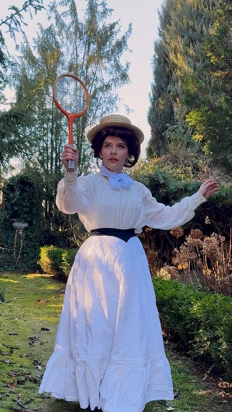 19th Century Fashion for Women: 8 Styles and Silhouettes 2 Woman in white Victorian sportswear holding a vintage wooden tennis racket in a garden