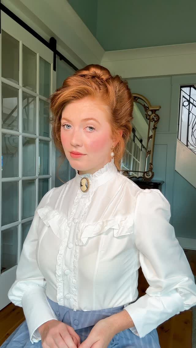 19th Century Fashion for Women: 8 Styles and Silhouettes 3 Woman with red updo wearing a Victorian white ruffled blouse and blue skirt.