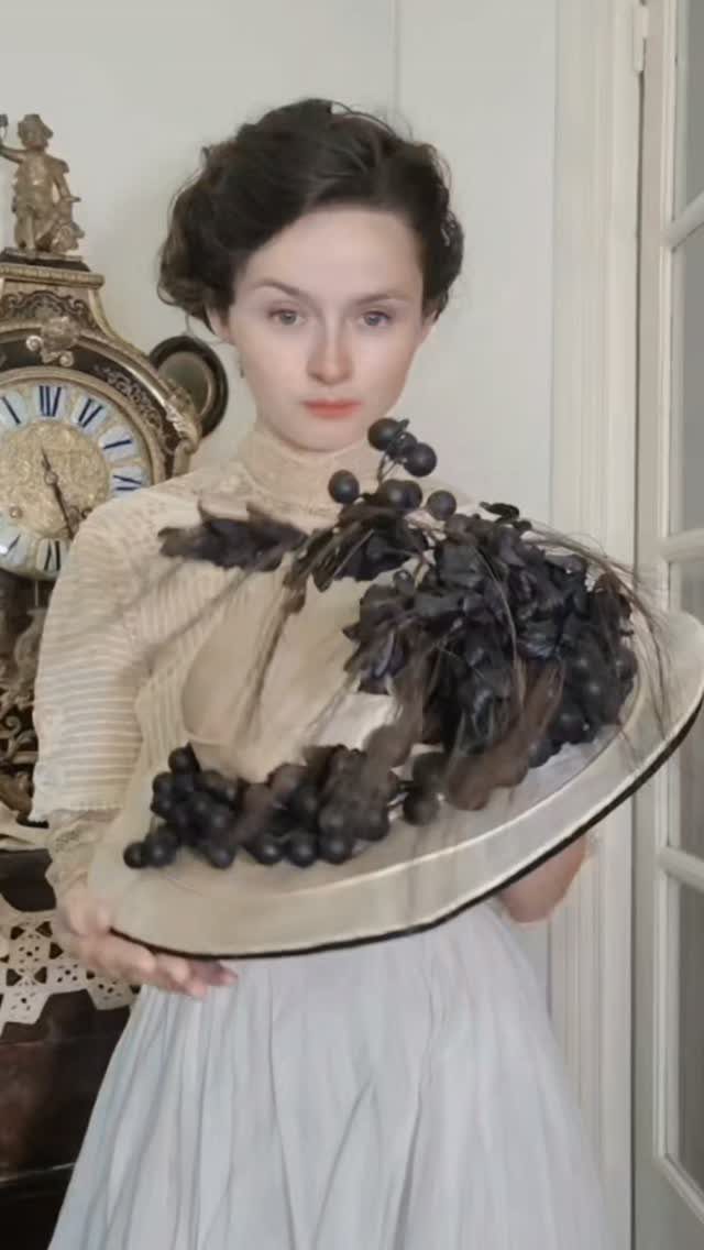 19th Century Fashion for Women: 8 Styles and Silhouettes 7 Woman in 19th century style clothing holding a platter of dark grapes.
