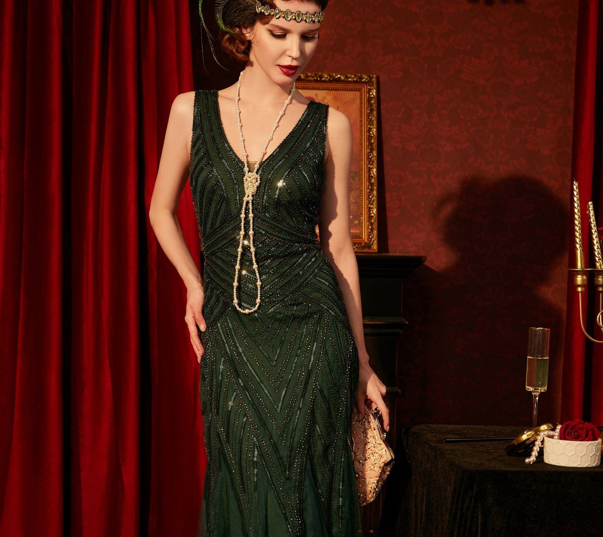 Woman in a dark green Art Deco sequin dress with vintage jewelry and headband.
