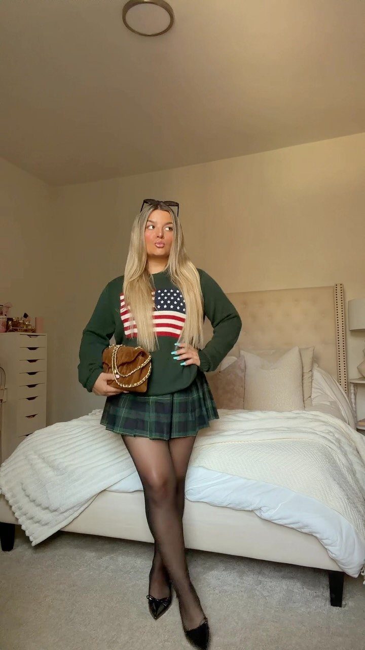 90s Skirt Outfits: 7 Ideas, from Floral Maxi to Mini 2 Woman wearing a green plaid mini skirt and American flag sweater in a bedroom
