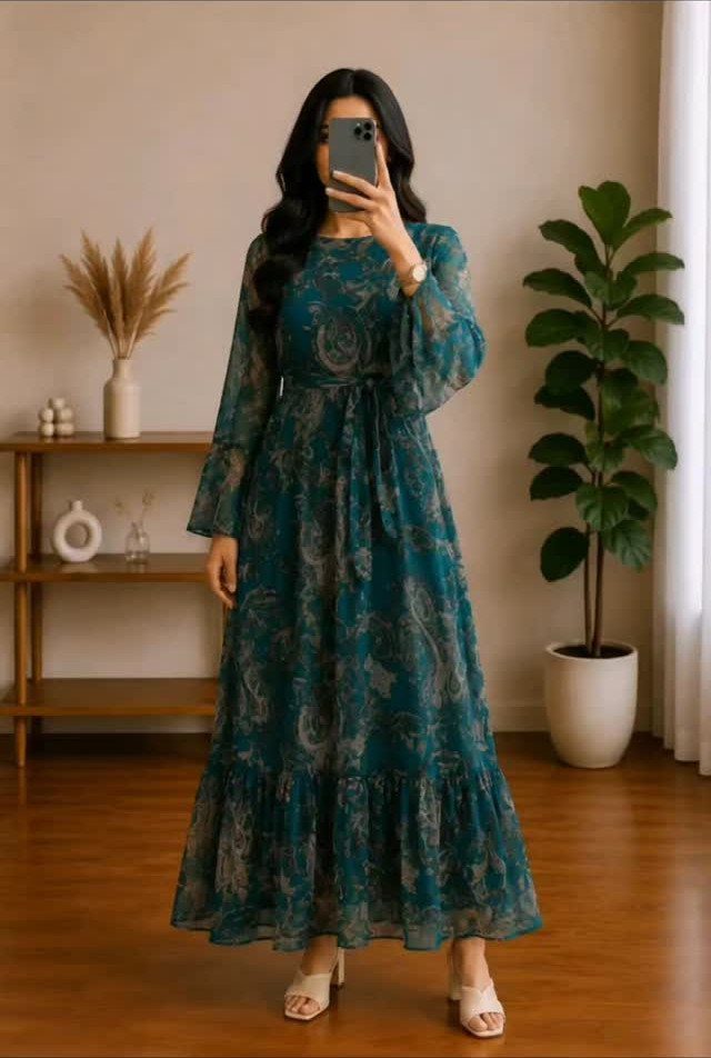 Woman in a teal paisley flowy maxi dress and white block heels.