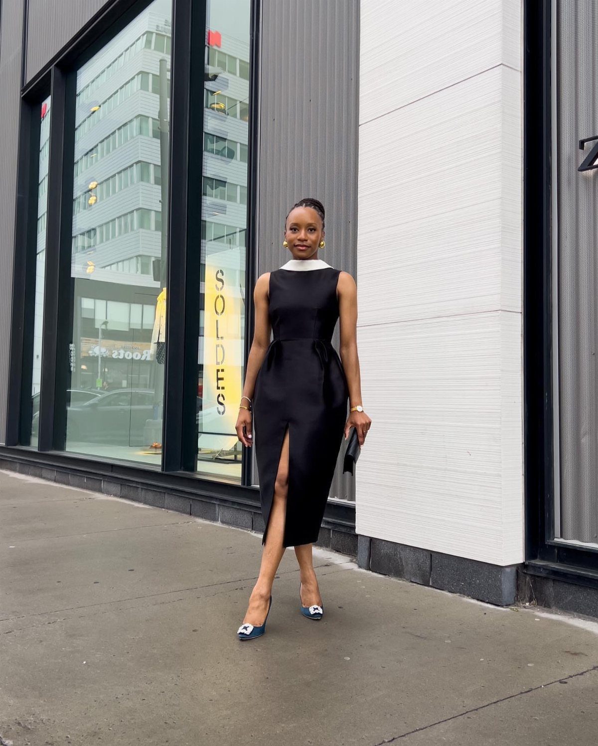 6 Black Dress Design Ideas for Formal and Wedding Looks 6 Woman in a sleeveless black midi dress with white collar and blue heels.
