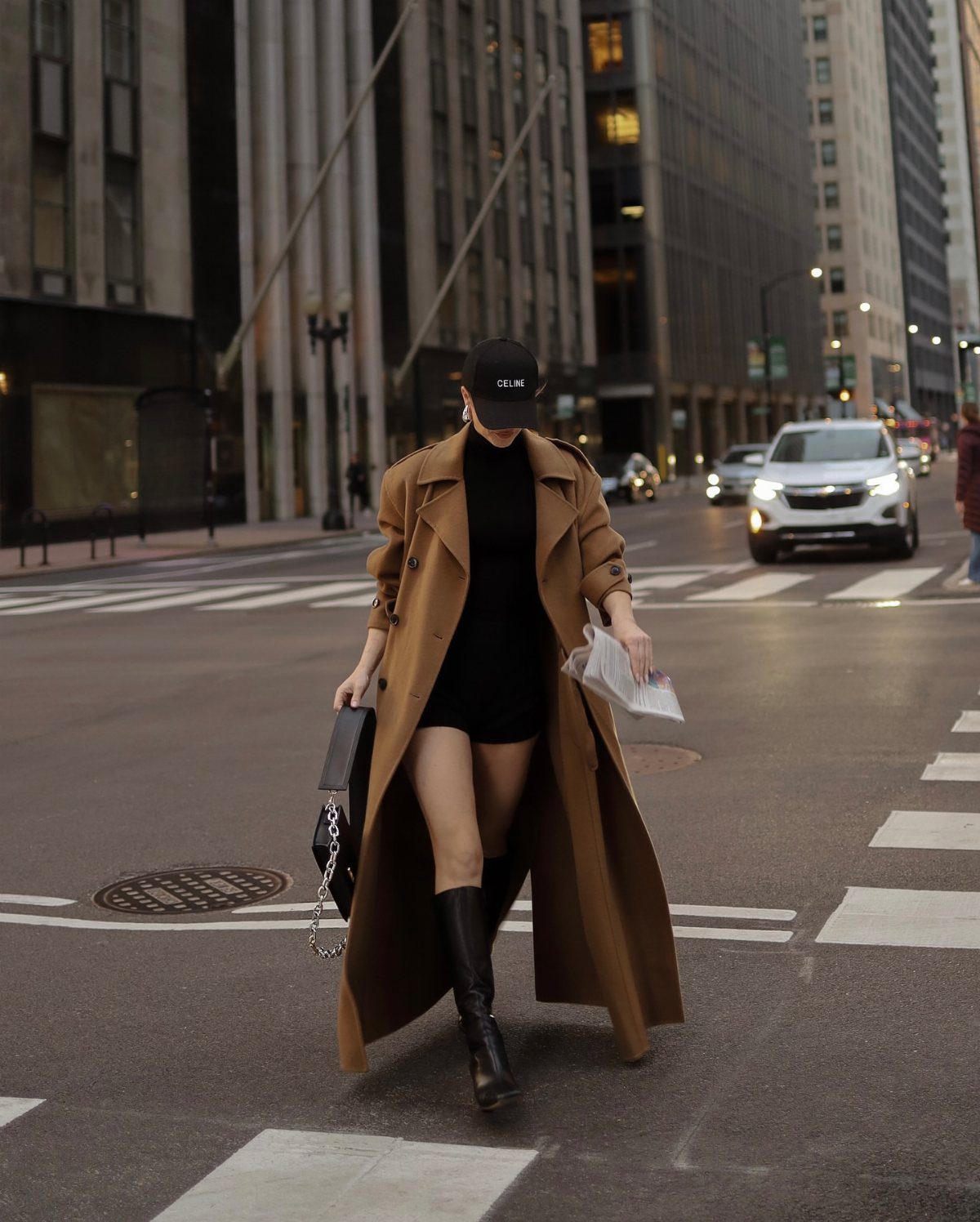 Black or Brown Boots for Every Outfit: 8 Ideas to Wear 1 Person in tan trench coat and black dress wearing black leather boots.