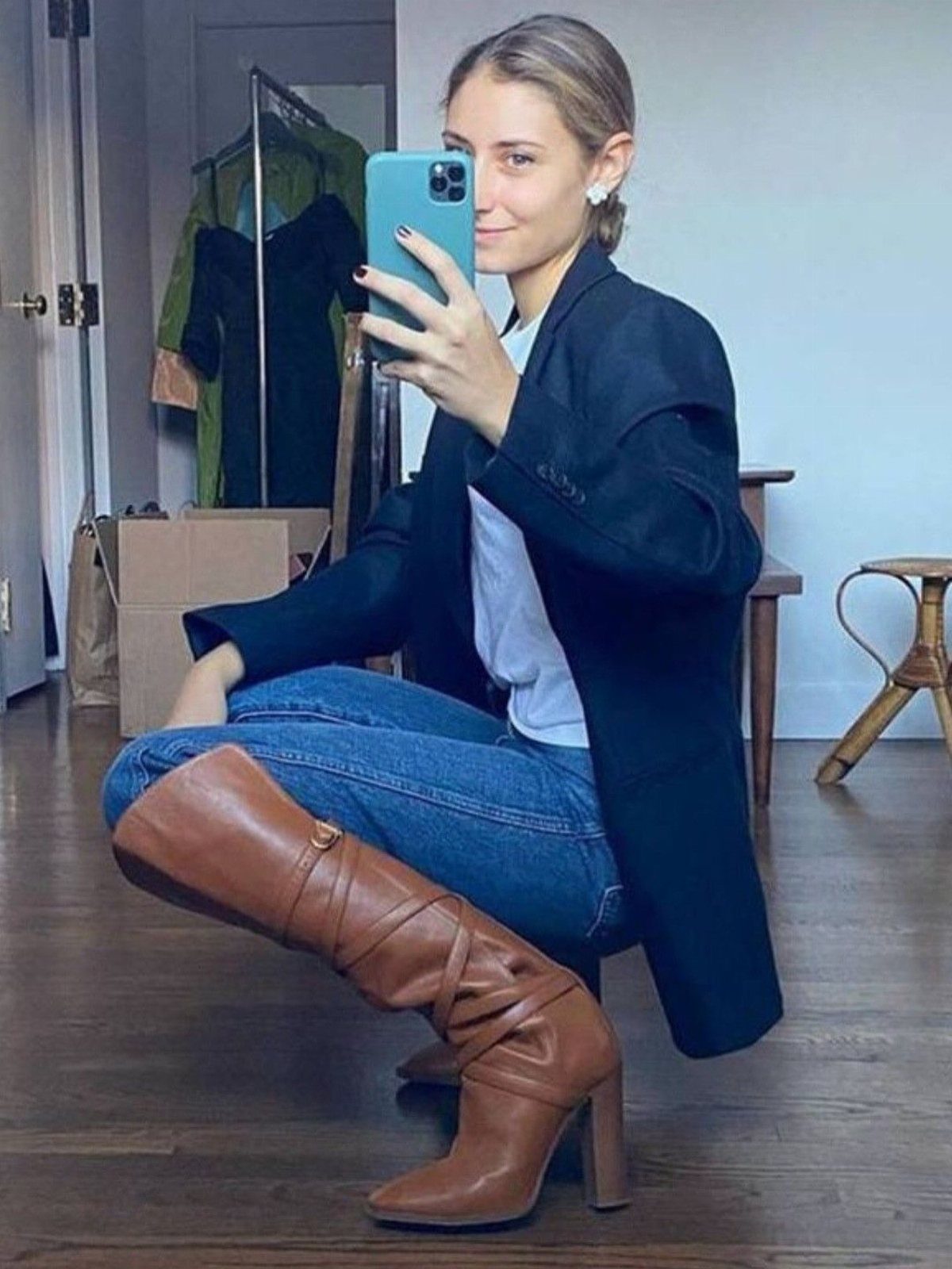 Black or Brown Boots for Every Outfit: 8 Ideas to Wear 6 Woman in a black blazer and blue jeans wearing tall brown leather boots.
