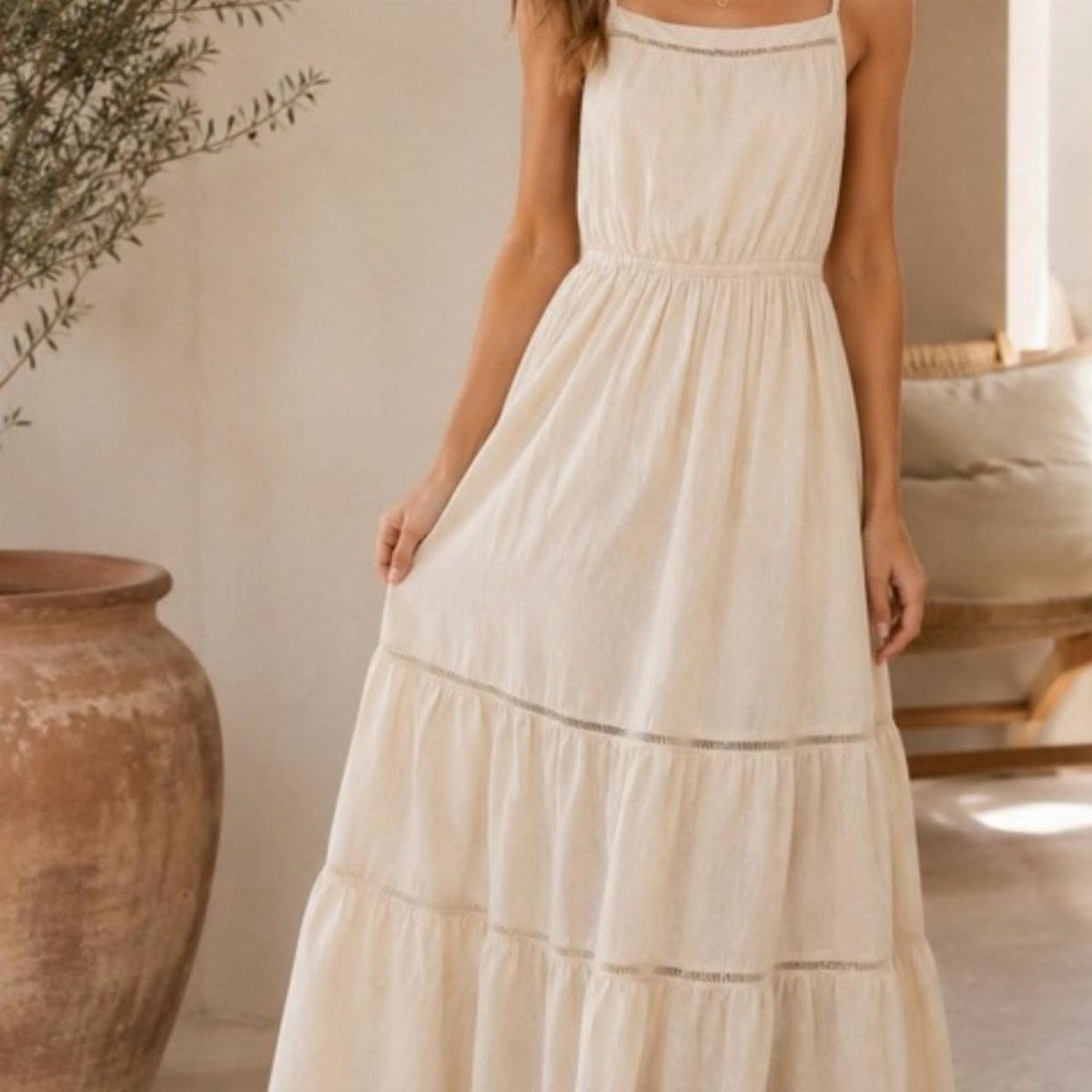 Bohemian Cream Dress Ideas: 9 Ways to Wear One 8 Woman wearing a long cream tiered maxi dress in a neutral indoor setting