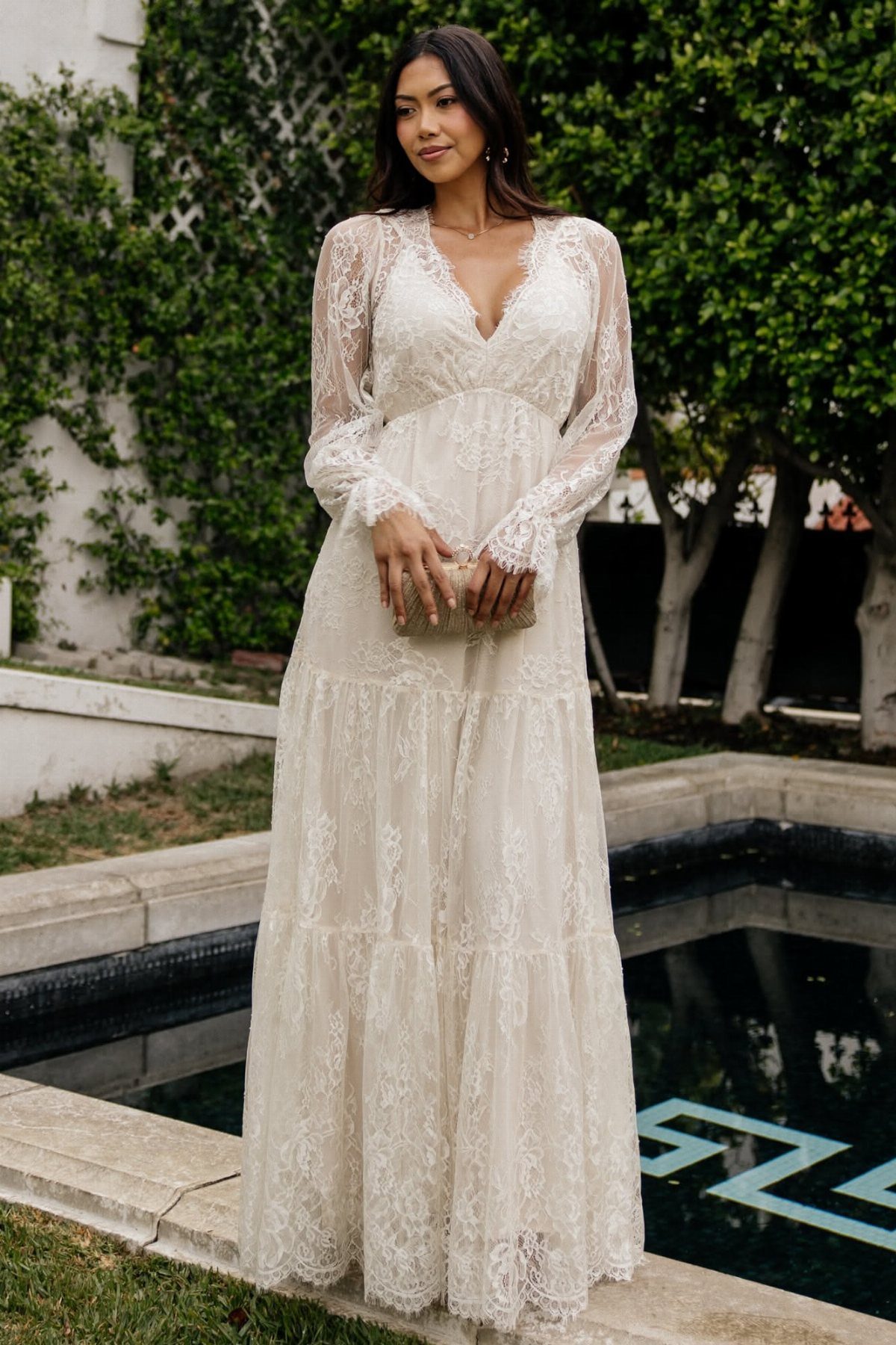 Boho Cream Dress Ideas: 7 Linen, Lace and Cotton Styles 5 Woman in a cream lace maxi dress with long sleeves and tiered skirt.