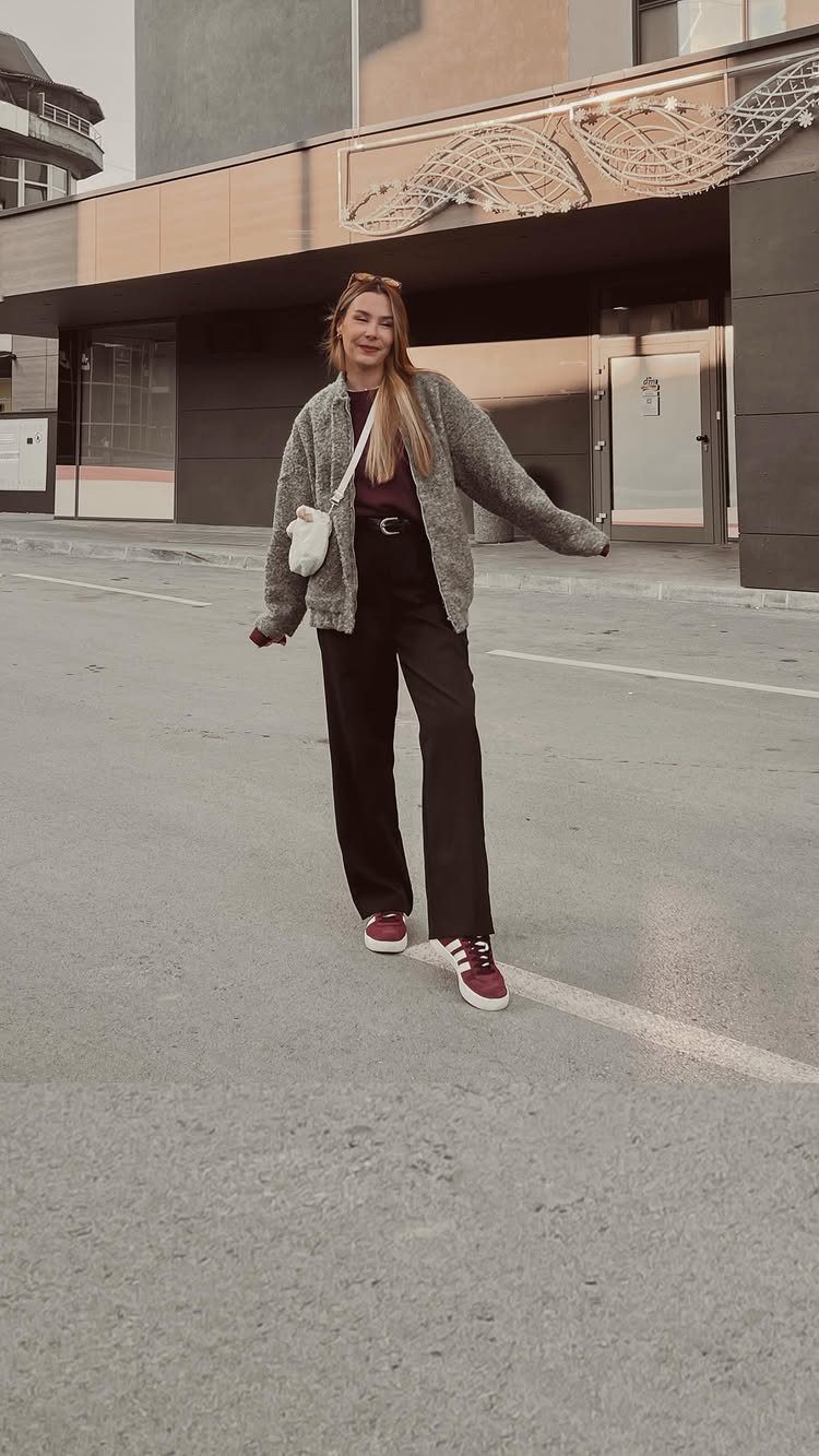 Burgundy Adidas Campus Outfit Ideas: 5 Ways to Wear Them 5 Woman wearing burgundy sneakers, black wide-leg trousers, and a grey cardigan on a street.