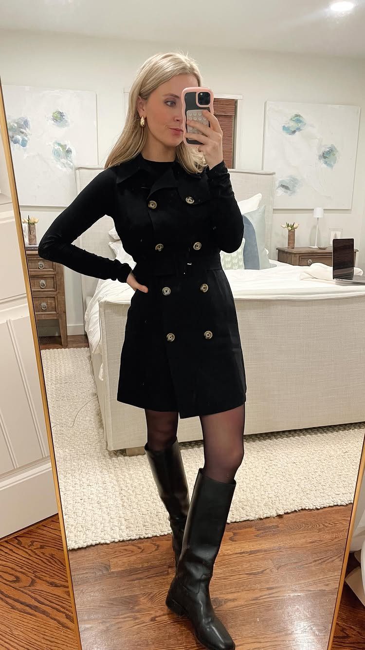 Woman wearing an all-black outfit with a mini dress and knee-high boots.