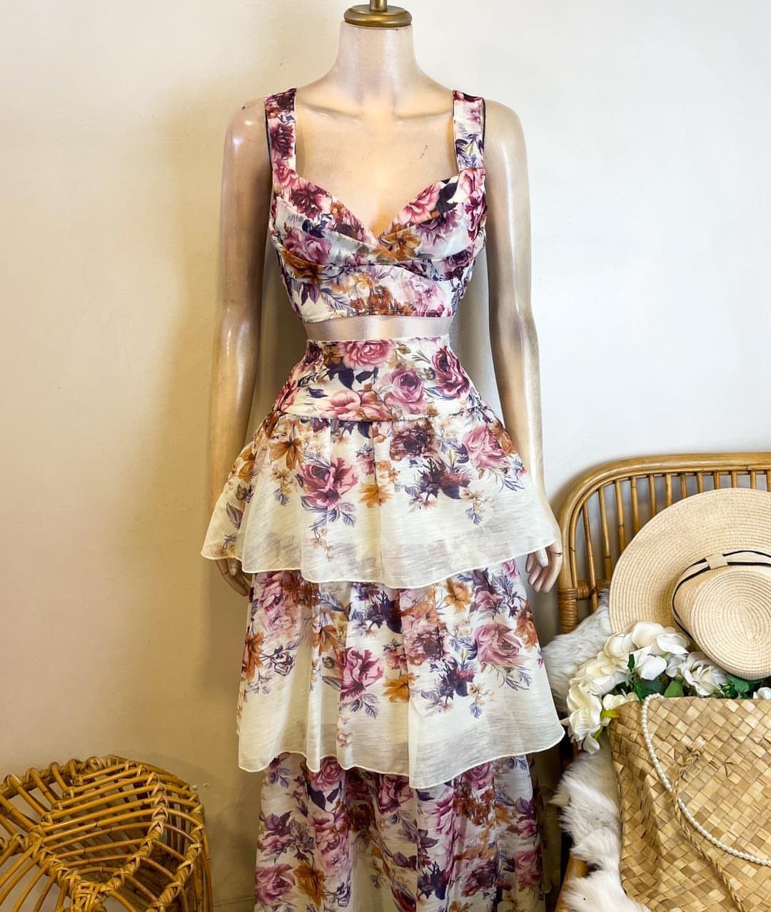 Floral print dress with a tiered skirt displayed on a mannequin.