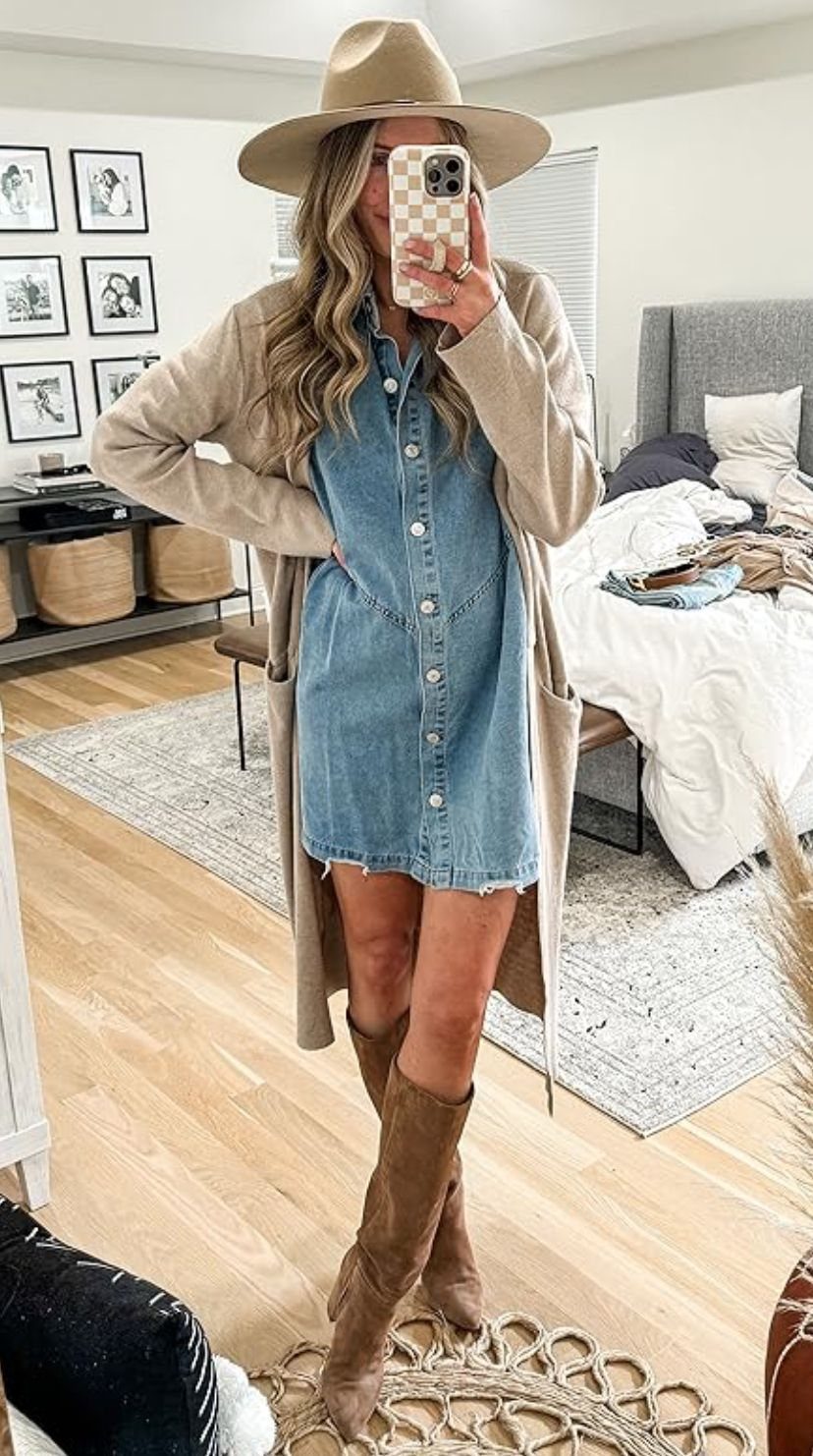 Woman wearing a blue denim mini dress with a long beige cardigan and boots.