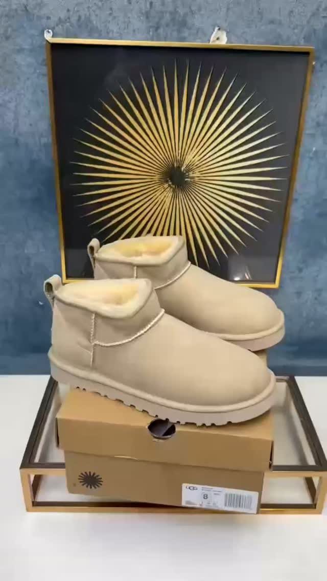 7 Different Types of Uggs for Every Season and Style 7 Beige sheepskin boots on a cardboard box in front of sunburst art.