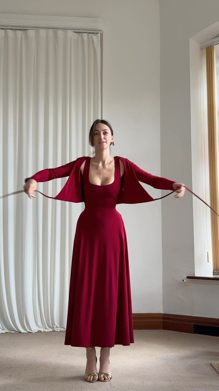 6 Elegant Long Sleeve Evening Dress Ideas for Formal Events 4 Woman in a long red evening dress with a matching long-sleeved shrug.