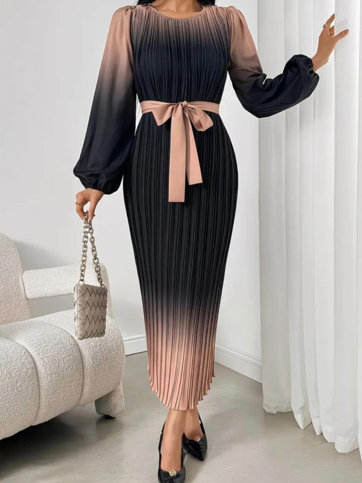 6 Elegant Long Sleeve Evening Dress Ideas for Formal Events 2 Woman wearing a pleated ombre black and champagne midi dress with long sleeves.
