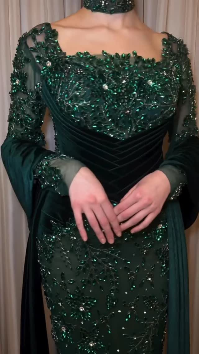 Emerald green velvet dress with sparkling beadwork and long sheer sleeves.