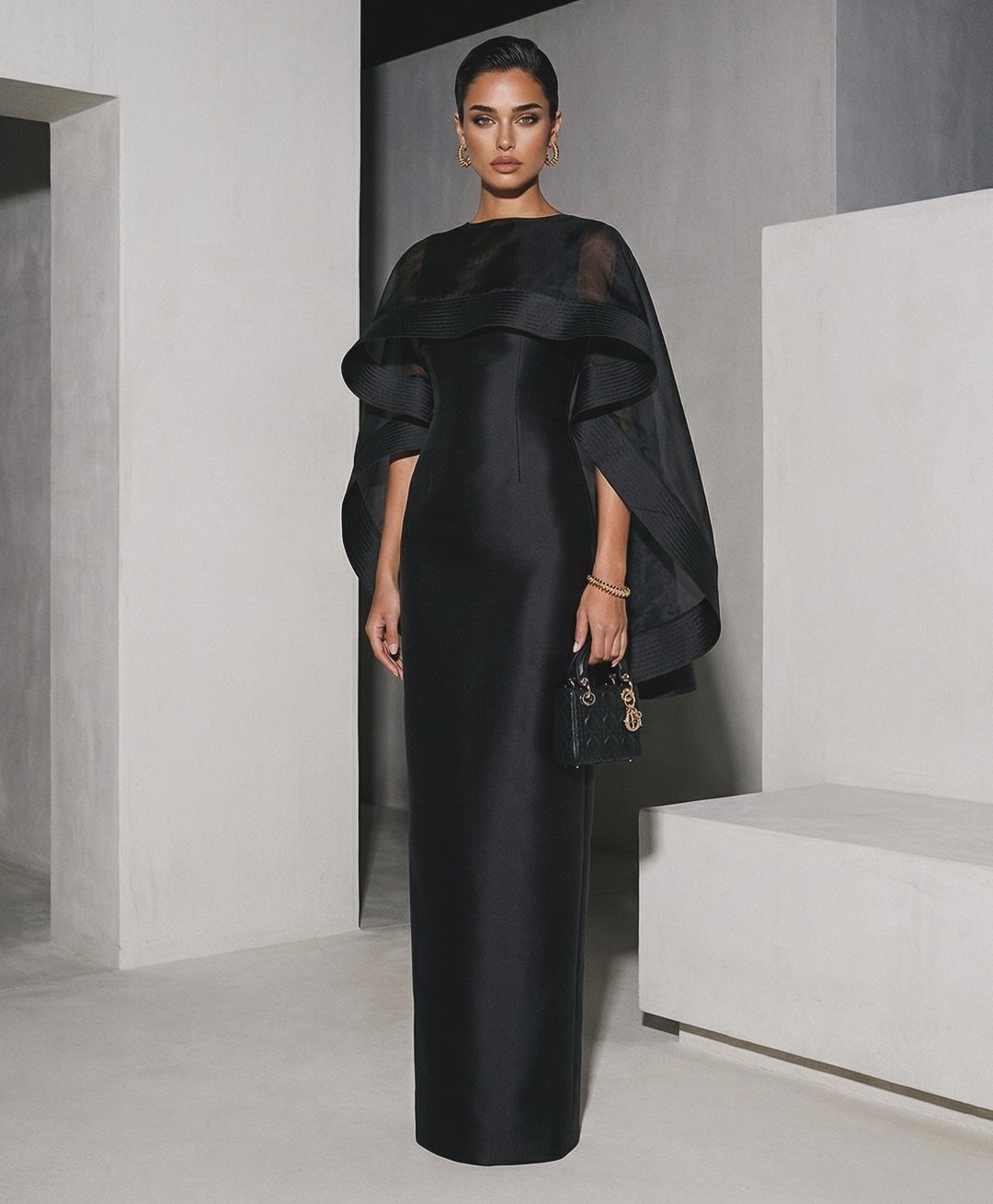 Evening Dress Luxury: 9 Gown Ideas in Satin and Sequins 4 Woman in a sleek black satin column gown with a sheer ruffled capelet.