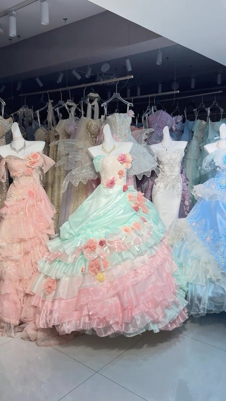 Fairy Tail Dress Ideas: 6 Styles for Fairytale Looks 2 Mint green and pink tiered ball gown with floral accents on a mannequin