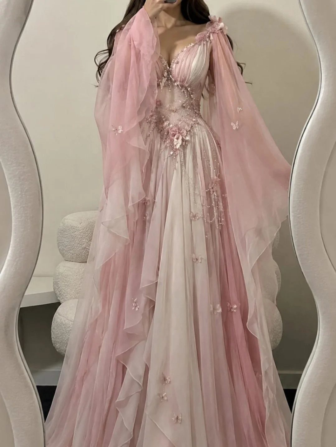 Fairy Tail Dress Ideas: 6 Styles for Fairytale Looks 4 Pink tulle ball gown with floral appliqués and flowing cape sleeves on a person