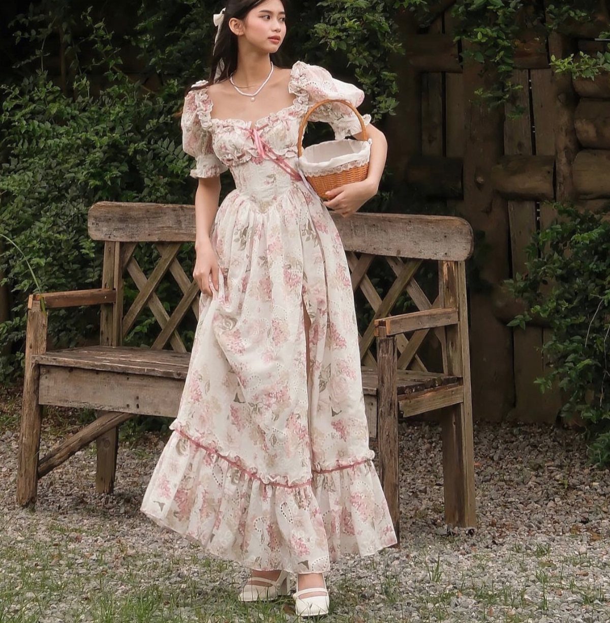 Fairy Tail Dress Ideas: 6 Styles for Fairytale Looks 3 Woman in a floral fairycore dress holding a wicker basket by a wooden bench