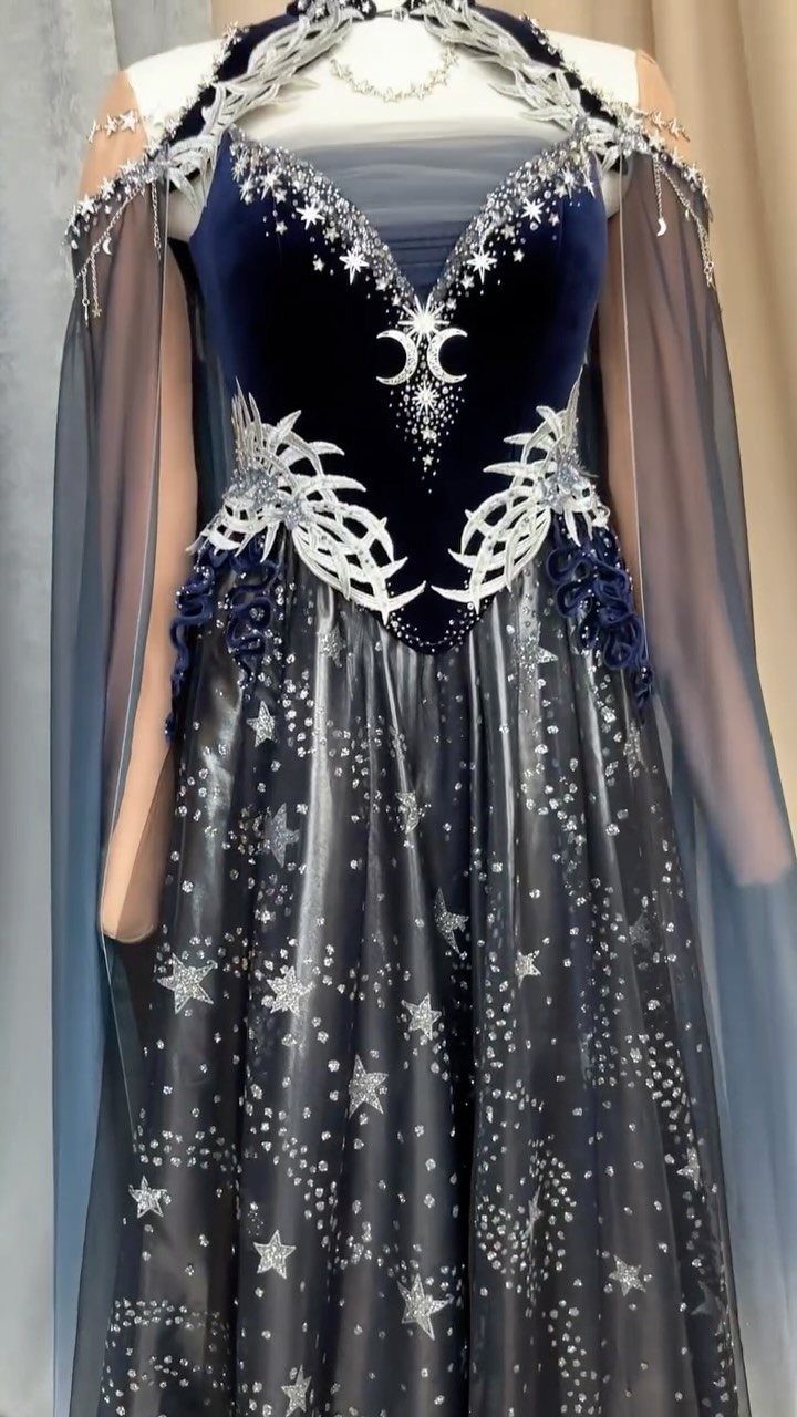 Navy blue celestial gown with silver stars and a matching sheer cape.
