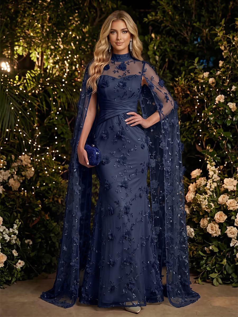 Woman in a navy blue tulle gown with a matching sheer cape and embroidery.