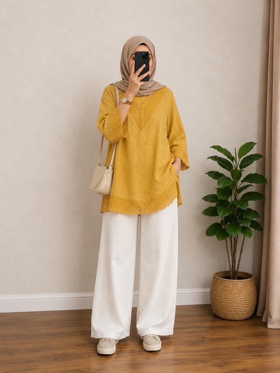 How to Style a Tunic: 9 Ideas From Jeans to Shorts 5 Person in mustard yellow lightweight tunic, white wide-leg trousers, and tan hijab.