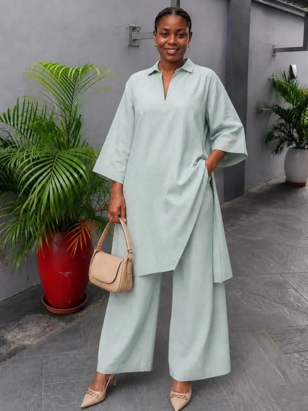 How to Style a Tunic: 9 Ideas From Jeans to Shorts 4 Woman wearing a mint green tunic and matching wide-leg tailored trousers with beige heels.