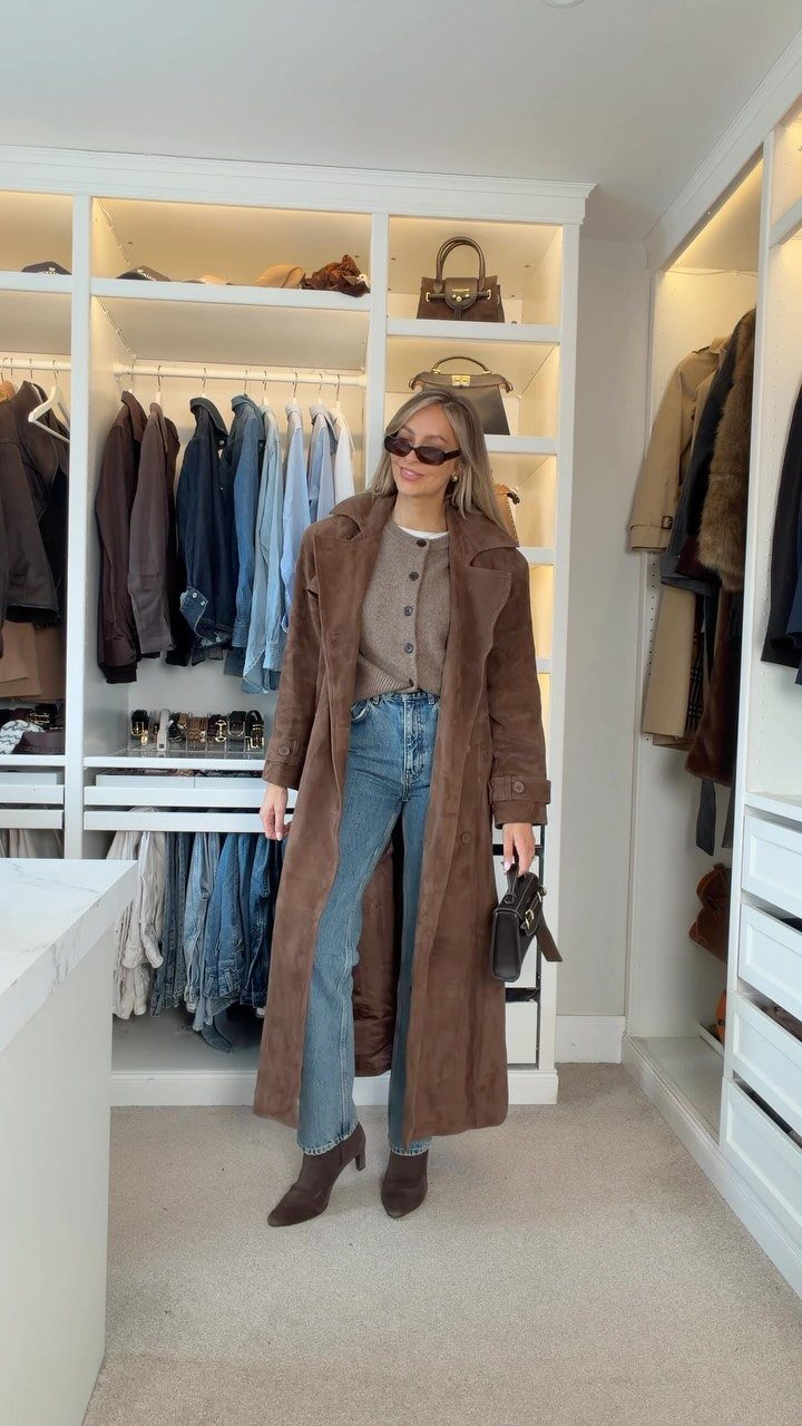 Woman in a walk-in closet wearing blue jeans and brown ankle boots.