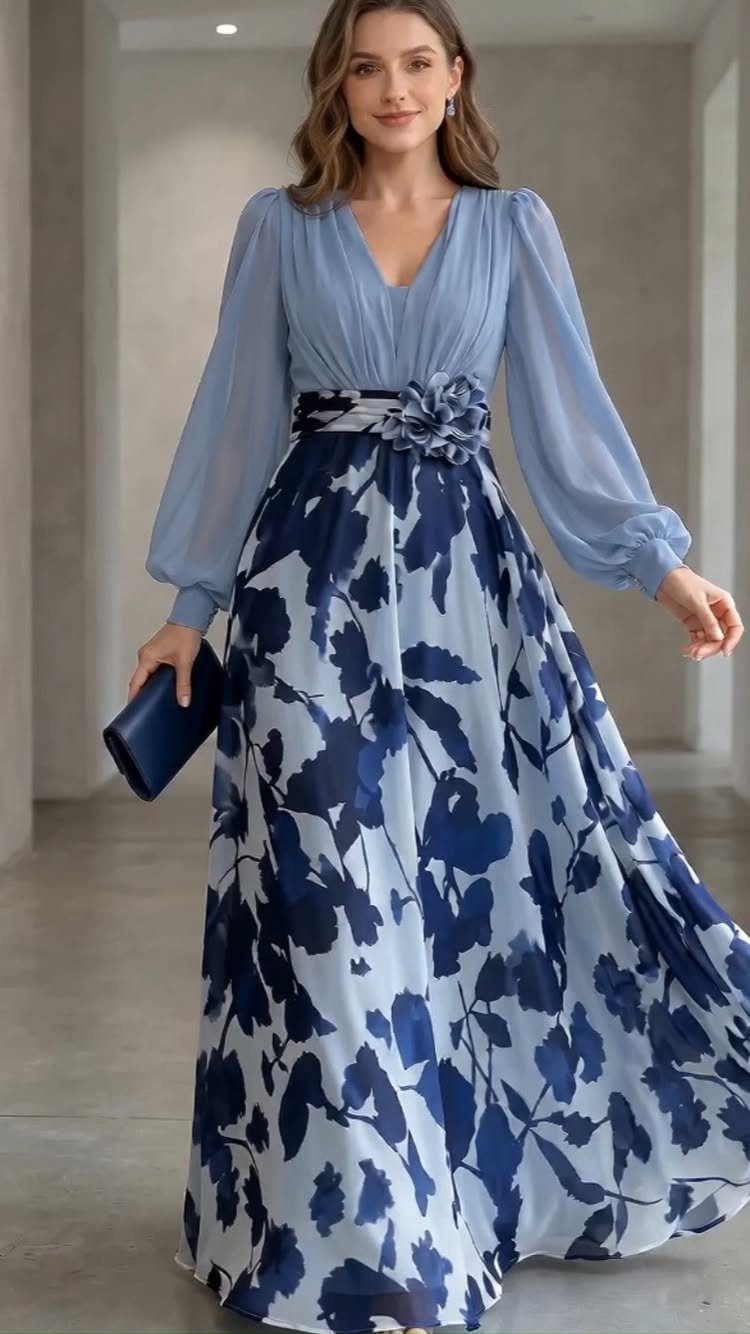 10 Luxury Dress for Wedding Guest Ideas and Styles 10 Woman in a light blue floral chiffon maxi dress holding a navy clutch.