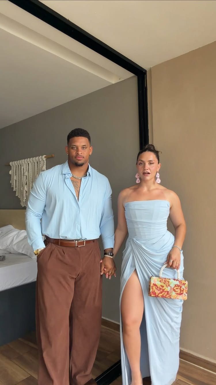 10 Luxury Dress for Wedding Guest Ideas and Styles 2 Woman in light blue strapless draped maxi dress posing with man in blue shirt.