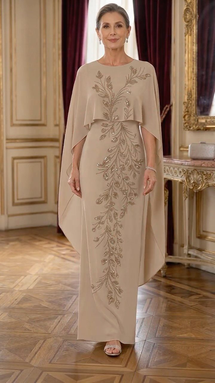 10 Luxury Dress for Wedding Guest Ideas and Styles 7 Woman in a beige formal gown with gold floral embroidery and a capelet.