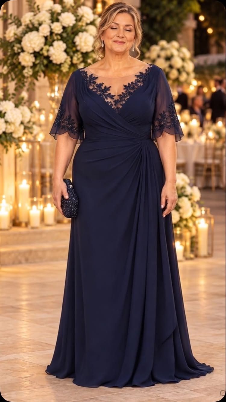 Navy Blue Ball Gown Ideas: 9 Styles From Tulle to Corset 8 Woman in navy blue gown with floral lace embroidery on the bodice and sleeves.