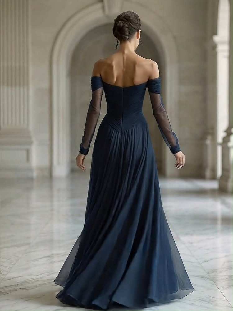 Navy Blue Ball Gown Ideas: 9 Styles From Tulle to Corset 1 Woman from behind in a navy blue off-the-shoulder gown in a marble hall