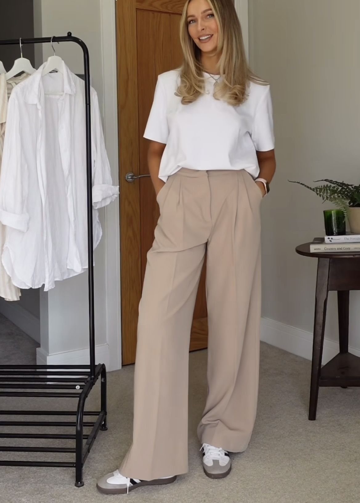 New Balance 9060 Sea Salt Moonbeam: 5 Outfit Ideas 1 Woman wearing beige wide-leg trousers and cream sneakers with a white t-shirt.