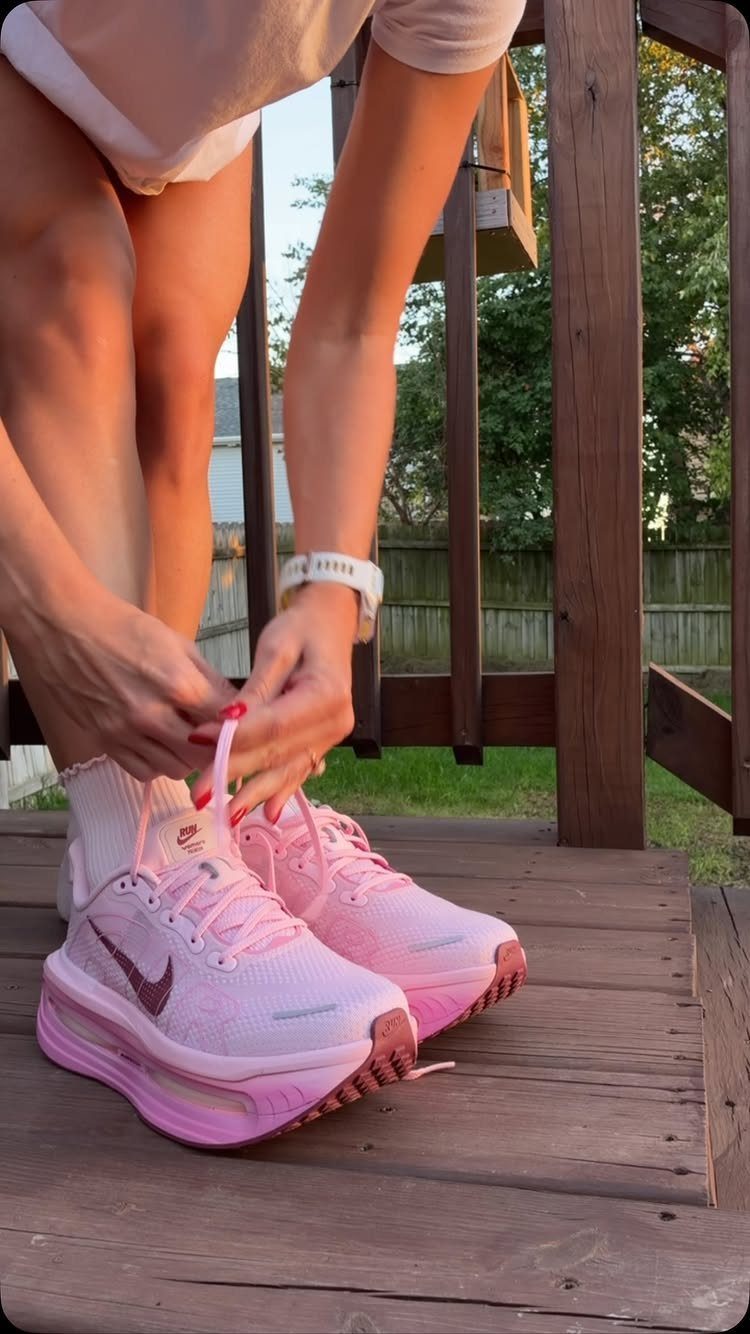 Nike Balance Shoes: 8 Sneaker Ideas for Women 3 Pink Nike sneakers with thick soles being tied on a wooden deck