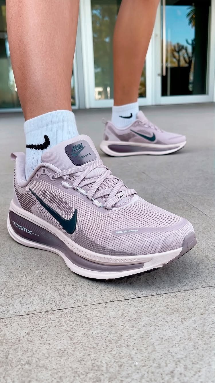 Nike Balance Shoes: 8 Sneaker Ideas for Women 4 Mauve Nike sneakers with white socks on a grey concrete pavement.