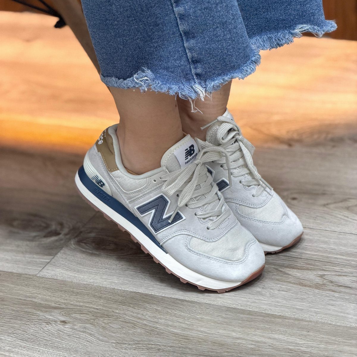 Nike Balance Shoes: 8 Sneaker Ideas for Women 1 Light grey New Balance sneakers with blue accents worn with frayed blue jeans.