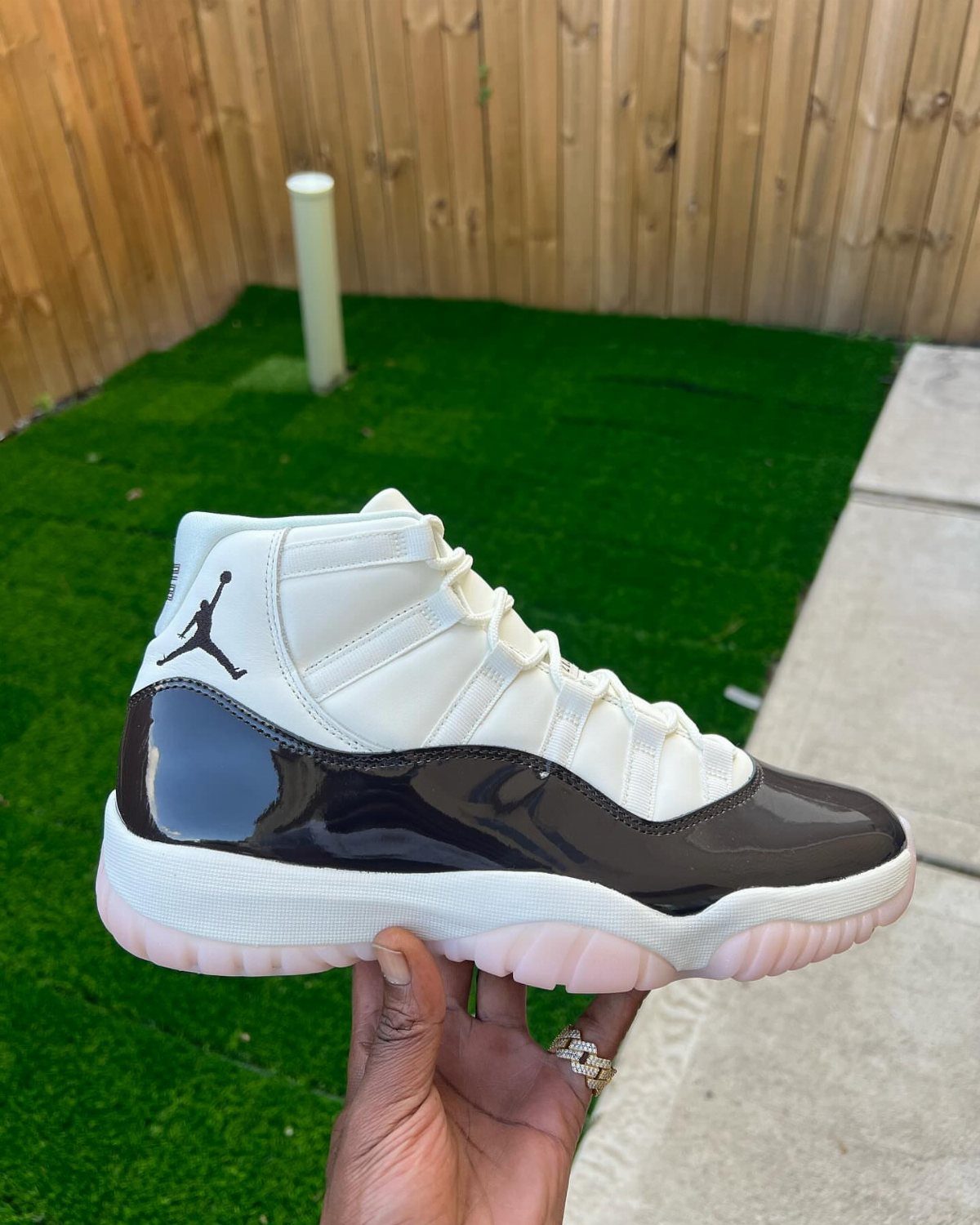 Nike Jordan Sneakers for Women: 12 Pairs to Know 3 Air Jordan 11 Neapolitan sneaker with white, brown, and pink colors held by hand.