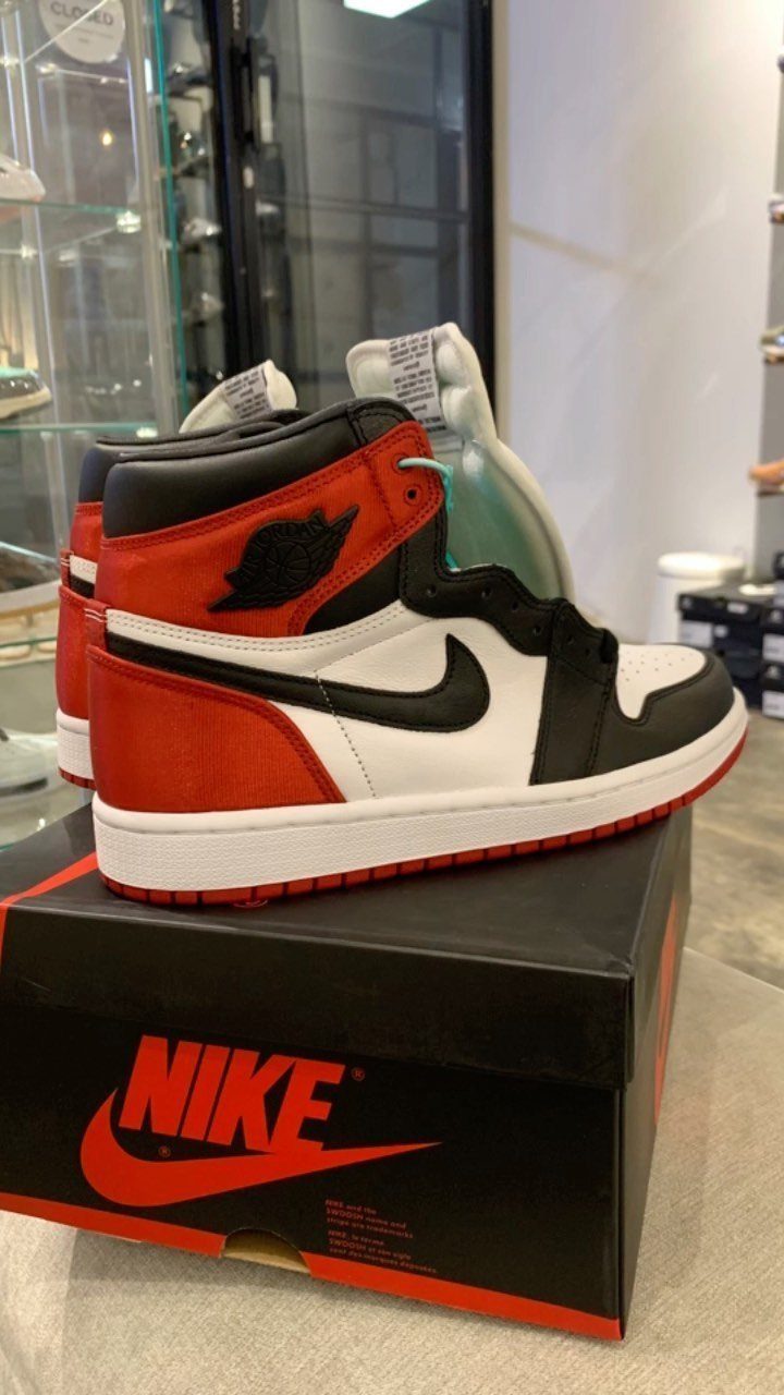 Nike Jordan Sneakers for Women: 12 Pairs to Know 7 Red, white, and black Air Jordan 1 sneakers sitting on a Nike shoebox.