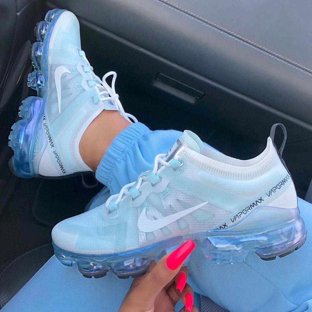 Light blue Nike Air VaporMax sneakers worn with matching blue joggers in a car