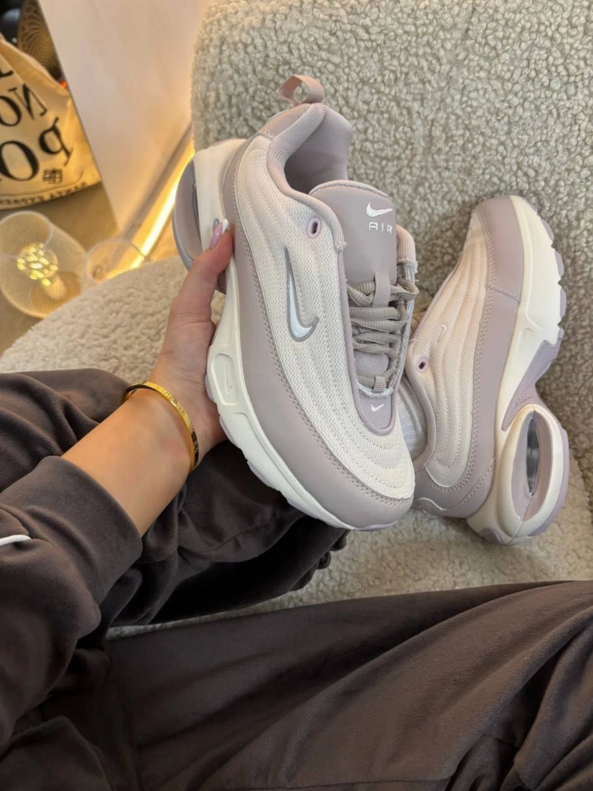 Light purple Nike Air Max sneakers with visible air cushioning on white fabric.