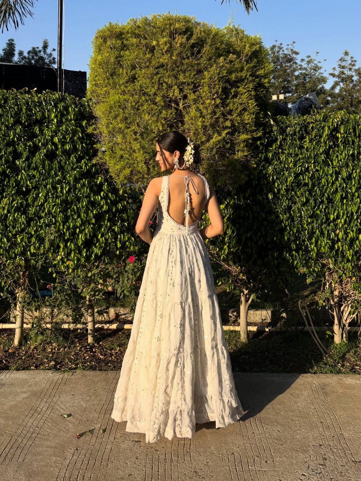 7 Off White Boho Dress Ideas for Every Occasion 6 Woman from behind wearing a long off-white boho dress with open back
