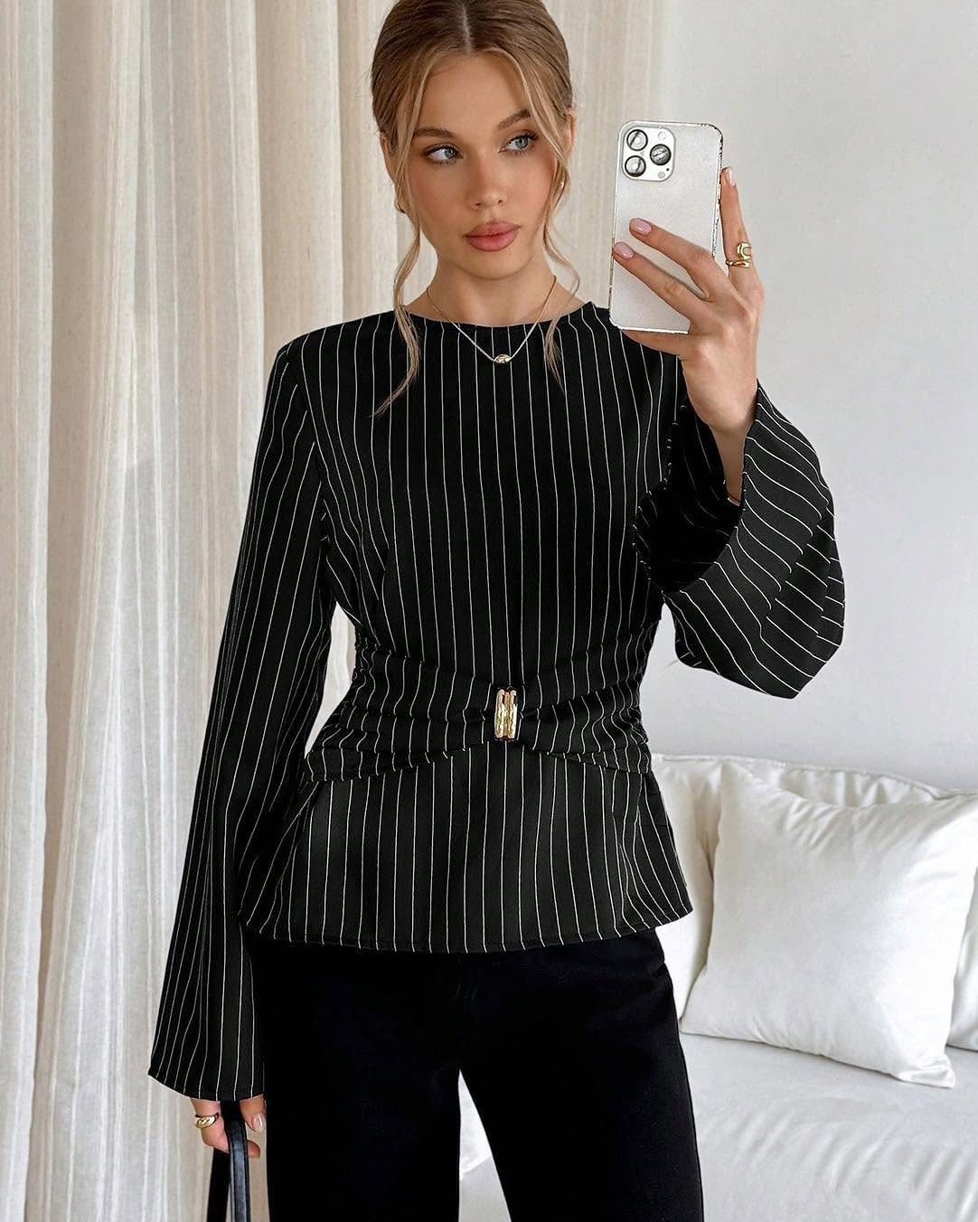 Woman wearing a black pinstripe business casual blouse with a gold waist buckle.