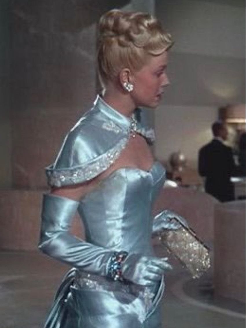 Woman in light blue satin strapless gown with matching long opera gloves.