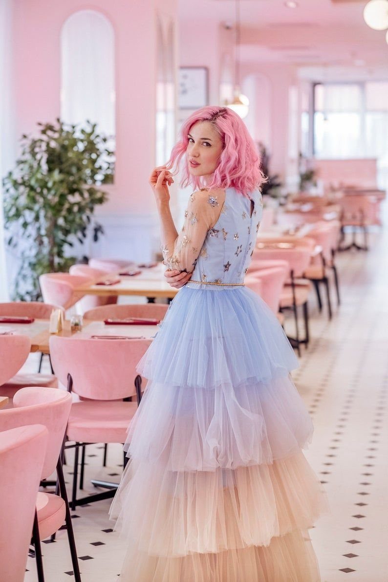 Pink and Blue Dresses: 7 Ideas for Every Style 5 Woman with pink hair wearing a blue and pink tiered tulle gown in cafe