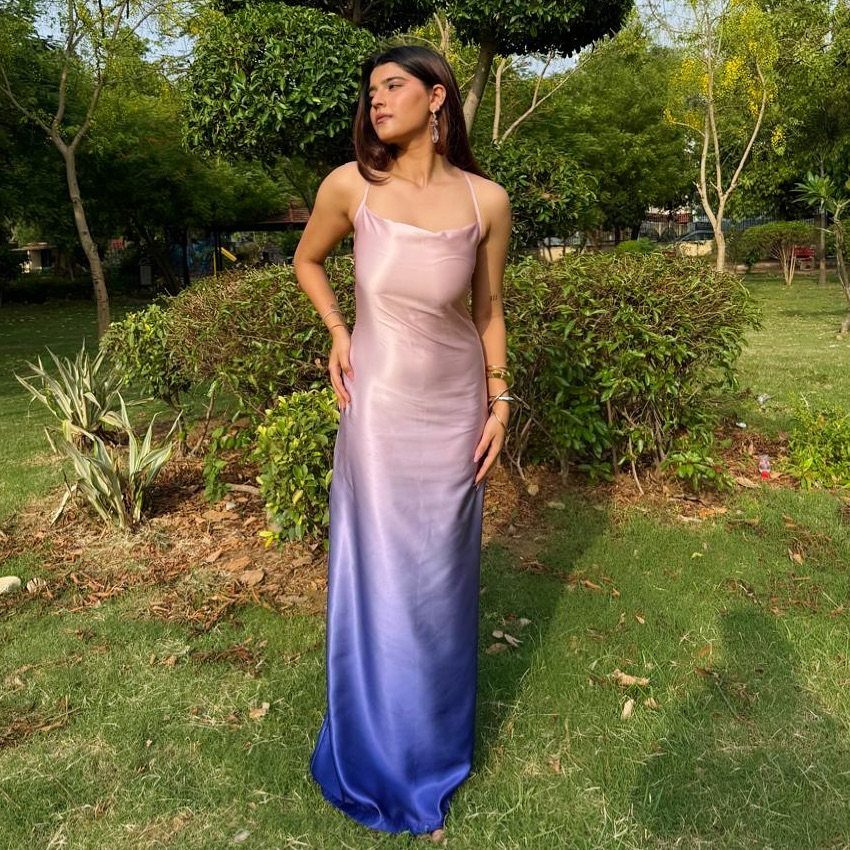 Pink and Blue Dresses: 7 Ideas for Every Style 4 Woman wearing a satin maxi dress with a pink to blue gradient effect.