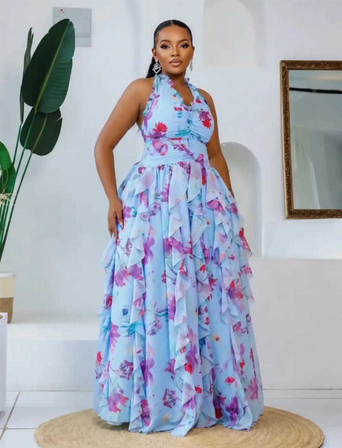 Pink and Blue Dresses: 7 Ideas for Every Style 3 Woman in a light blue sleeveless maxi dress with pink floral ruffles