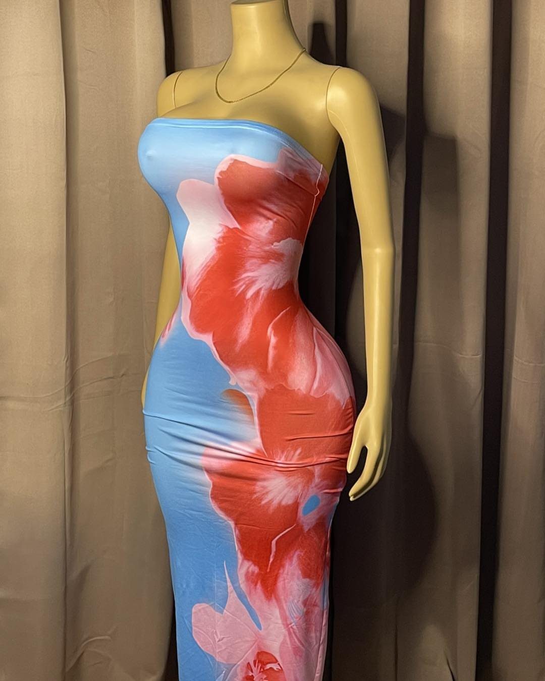 Pink and Blue Dresses: 7 Ideas for Every Style 6 Strapless blue dress with large pink floral prints on a tan mannequin.